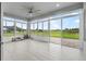 A sunroom patio has tiled floor and multiple windows overlooking the spacious backyard at 3345 Tesoro Cir, New Smyrna Beach, FL 32168