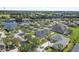 An aerial view of a beautiful neighborhood with a central lake and fountain surrounded by well-maintained homes and green landscaping at 3615 Marisol Ct, New Smyrna Beach, FL 32168