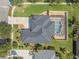 Aerial view of a beautiful home with a screened-in pool, landscaped yard, and patterned driveway at 3615 Marisol Ct, New Smyrna Beach, FL 32168