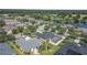 An aerial shot of a residential area featuring attractive houses with pools and verdant landscapes surrounding a central pond at 3615 Marisol Ct, New Smyrna Beach, FL 32168