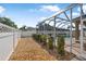 This backyard features a screened-in pool and a view of the surrounding trees at 3615 Marisol Ct, New Smyrna Beach, FL 32168