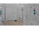 Modern bathroom with walk-in shower featuring sleek tilework, a toilet, and door at 3615 Marisol Ct, New Smyrna Beach, FL 32168