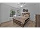 This bedroom features wood-look floors, a ceiling fan, and a neutral color scheme at 3615 Marisol Ct, New Smyrna Beach, FL 32168
