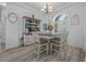 Charming dining area with a farmhouse table, stylish chairs, and an arched window at 3615 Marisol Ct, New Smyrna Beach, FL 32168