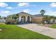 Attractive single-Gathering house with manicured lawn, palm trees, front garden with benches, and a spacious driveway at 3615 Marisol Ct, New Smyrna Beach, FL 32168