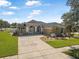 Charming single-story home with well-manicured lawn, decorative driveway, and a welcoming front porch at 3615 Marisol Ct, New Smyrna Beach, FL 32168