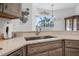 Kitchen sink featuring stainless steel fixtures, granite countertops, and views through the window at 3615 Marisol Ct, New Smyrna Beach, FL 32168