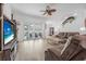 Living room with sliding doors to lanai and pool; comfortable seating and a ceiling fan at 3615 Marisol Ct, New Smyrna Beach, FL 32168