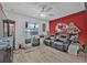 This living room boasts a ceiling fan, wood-look floors, and a wall mural at 3615 Marisol Ct, New Smyrna Beach, FL 32168