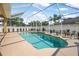 This screened-in pool features a fountain and a view of the surrounding trees at 3615 Marisol Ct, New Smyrna Beach, FL 32168