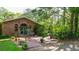 Large brick backyard patio surrounded by lush landscaping and views of tall trees at 3720 Willow Ave, Deland, FL 32720