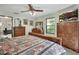 Serene bedroom with a ceiling fan, complemented by natural light and wooden furniture at 3720 Willow Ave, Deland, FL 32720