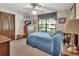 Bedroom features a ceiling fan, a large window, and soft, neutral colors at 3720 Willow Ave, Deland, FL 32720