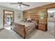 Stylish bedroom with natural wood wall, providing a peaceful and inviting retreat at 3720 Willow Ave, Deland, FL 32720