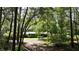 Single-story home nestled among trees, offering a charming front porch and well-maintained landscaping at 3720 Willow Ave, Deland, FL 32720
