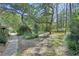 Landscaped front yard with mature trees and lush greenery, creating a serene and private setting at 3720 Willow Ave, Deland, FL 32720