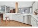 Bright kitchen with white cabinets, stainless steel appliances, and an adjoining open dining space at 3720 Willow Ave, Deland, FL 32720