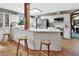 Bright kitchen featuring white cabinetry, stainless steel appliances, and a center island with seating at 3720 Willow Ave, Deland, FL 32720