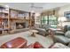 Cozy living room features a brick fireplace, built-in bookshelves, and comfortable seating arrangement at 3720 Willow Ave, Deland, FL 32720