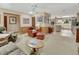 Open-concept living area with wood-paneled walls and seamless flow into the adjacent kitchen at 3720 Willow Ave, Deland, FL 32720
