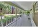 Spacious front porch with serene views of the lush, landscaped yard and surrounding greenery at 3720 Willow Ave, Deland, FL 32720