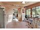 Bright sun room with brick floor and fitness equipment leads to bedroom at 3720 Willow Ave, Deland, FL 32720