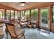 Enclosed sunroom with wicker furniture, wood accents, and multiple windows for natural light at 3720 Willow Ave, Deland, FL 32720