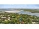 Beautiful aerial view showcases home near a waterway surrounded by trees at 4901 Sailfish Dr, Ponce Inlet, FL 32127