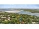 Beautiful aerial perspective showcasing the property's serene environment with lush greenery and water nearby at 4901 Sailfish Dr, Ponce Inlet, FL 32127