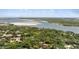 Scenic aerial view of the property with a beautiful lush landscape and waterfront nearby at 4901 Sailfish Dr, Ponce Inlet, FL 32127