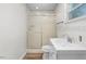 Bright bathroom with a sliding glass door shower and updated vanity at 4901 Sailfish Dr, Ponce Inlet, FL 32127