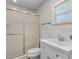 Bathroom features a glass-enclosed shower and a vanity with a white sink at 4901 Sailfish Dr, Ponce Inlet, FL 32127