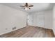 Bedroom features wood-look flooring, ceiling fan and closet at 4901 Sailfish Dr, Ponce Inlet, FL 32127