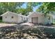 Attached two car garage with flat panel garage door and driveway at 4901 Sailfish Dr, Ponce Inlet, FL 32127