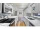 White kitchen features stainless appliances and quartz countertops at 4901 Sailfish Dr, Ponce Inlet, FL 32127