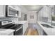 Kitchen features stainless appliances, quartz countertops and light backsplash at 4901 Sailfish Dr, Ponce Inlet, FL 32127