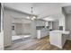 Open kitchen area with sleek countertops, light wood floors and a sliding door to the outdoor patio at 4901 Sailfish Dr, Ponce Inlet, FL 32127