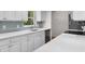 Well lit kitchen featuring white cabinets and quartz countertops at 4901 Sailfish Dr, Ponce Inlet, FL 32127