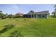 Spacious backyard showcasing an enclosed patio, and lush green lawn at 516 Spotted Sandpiper Dr, Daytona Beach, FL 32119