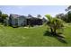 Lush backyard featuring a screened patio and an expansive green lawn, offering a perfect outdoor retreat at 516 Spotted Sandpiper Dr, Daytona Beach, FL 32119