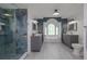 Elegant bathroom featuring double vanities, marble countertops, and glass shower at 516 Spotted Sandpiper Dr, Daytona Beach, FL 32119