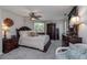 Comfortable bedroom with dark wood furniture, neutral carpet, and ceiling fan at 516 Spotted Sandpiper Dr, Daytona Beach, FL 32119
