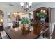 Dining room with dark wood table and chairs, with views into the kitchen at 516 Spotted Sandpiper Dr, Daytona Beach, FL 32119