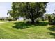 Charming single-story home with well-manicured lawn, mature shade tree, and an attached two-car garage at 516 Spotted Sandpiper Dr, Daytona Beach, FL 32119