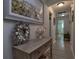 Hallway with coastal decor, artwork, and a glimpse of a bathroom at 516 Spotted Sandpiper Dr, Daytona Beach, FL 32119