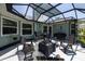 Screened patio with outdoor seating, a table, and a grill for entertaining in a comfortable outdoor setting at 516 Spotted Sandpiper Dr, Daytona Beach, FL 32119