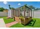 Outdoor shed and fenced garden on a lush green lawn at 934 Tall Pine Dr, Port Orange, FL 32127