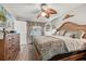 Bedroom with a large window, wood furniture, ceiling fan, and a light color scheme at 934 Tall Pine Dr, Port Orange, FL 32127