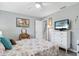 Bedroom with TV, ceiling fan, and large window for natural light at 934 Tall Pine Dr, Port Orange, FL 32127