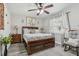 Comfortable bedroom features wood furnishings, a ceiling fan, and a sunlit window at 934 Tall Pine Dr, Port Orange, FL 32127